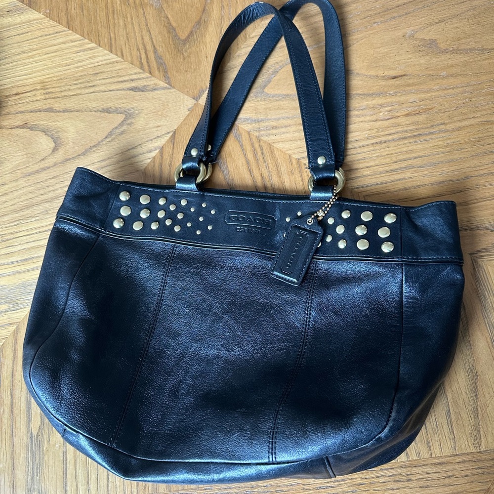 Coach purse black with gold studs, purple lining